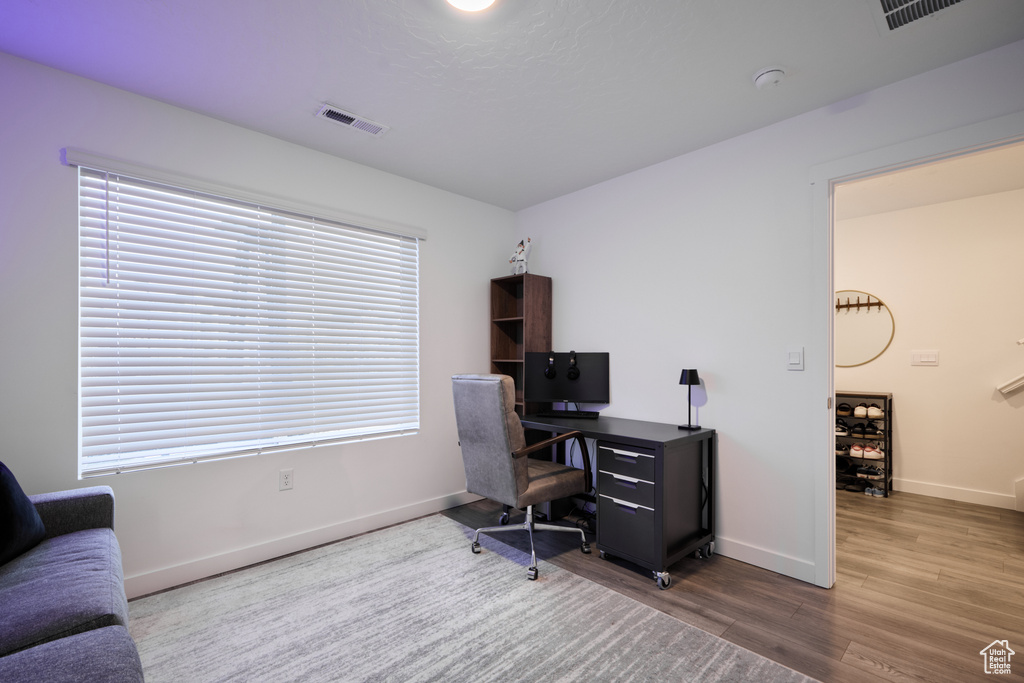 Home office featuring wood finished floors and baseboards