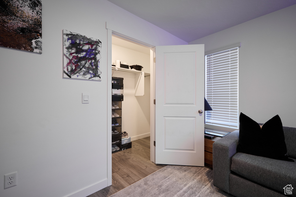 Living area with wood finished floors and baseboards