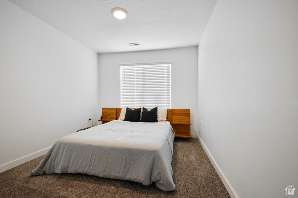 Carpeted bedroom with baseboards