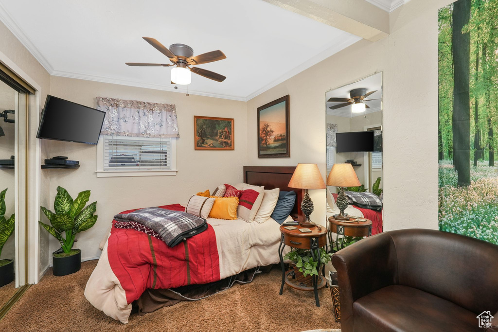 Carpeted bedroom featuring crown molding and ceiling fan