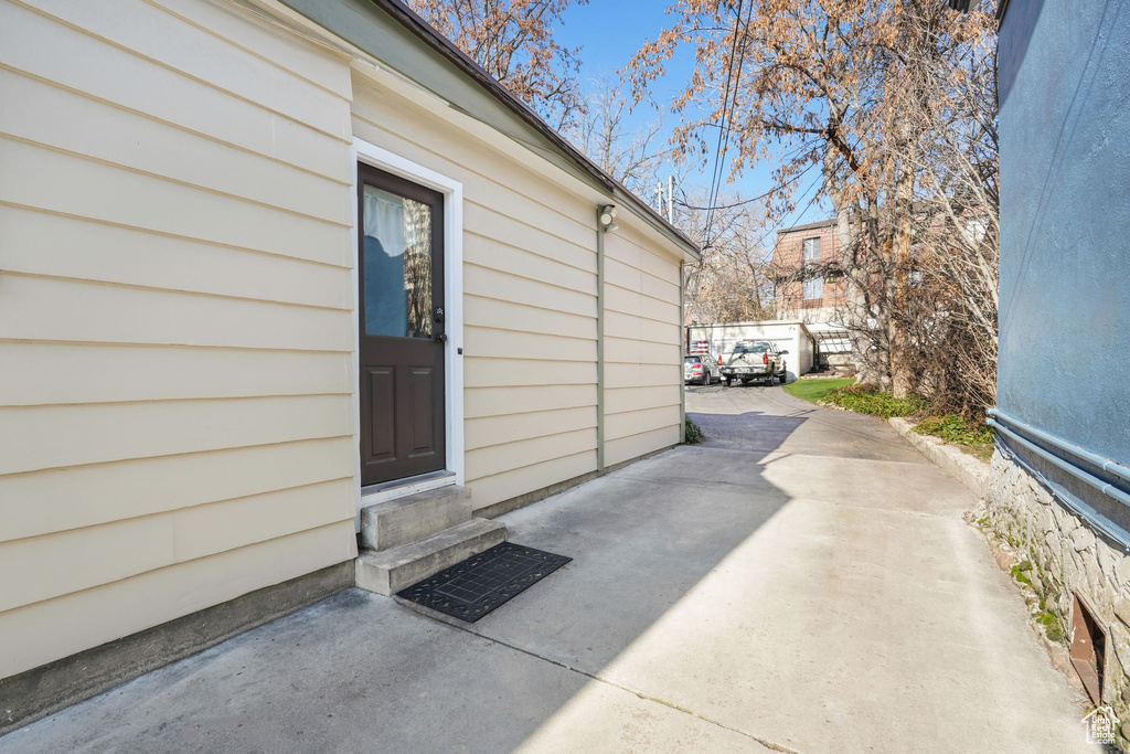 Doorway to property featuring a patio