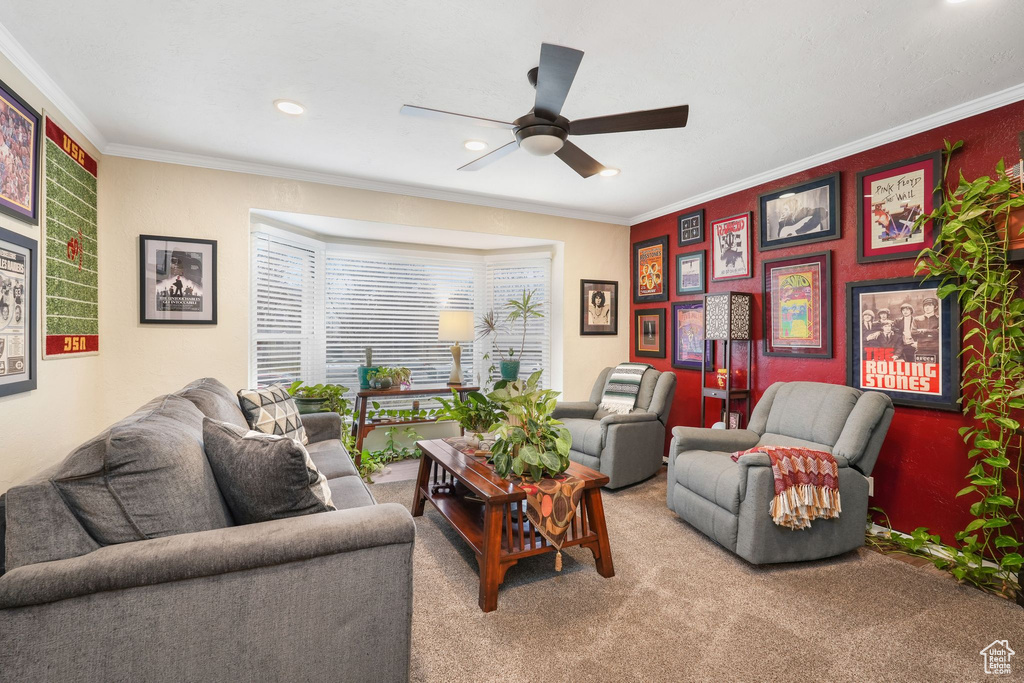 Carpeted living room with a ceiling fan, crown molding, and recessed lighting