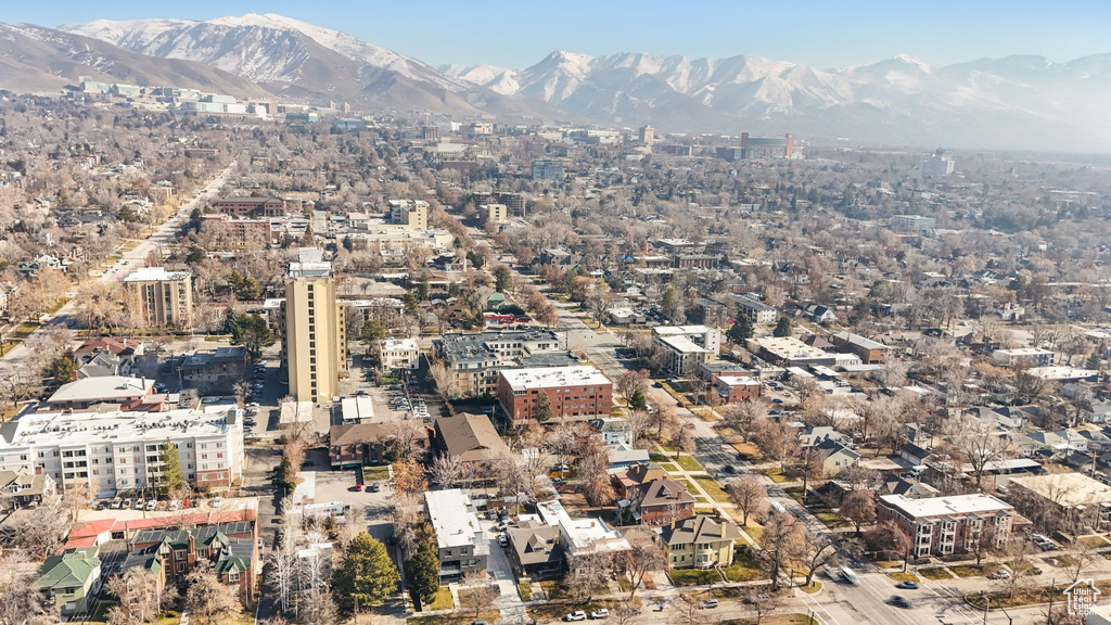 Aerial view of property and surrounding area with a mountain backdrop