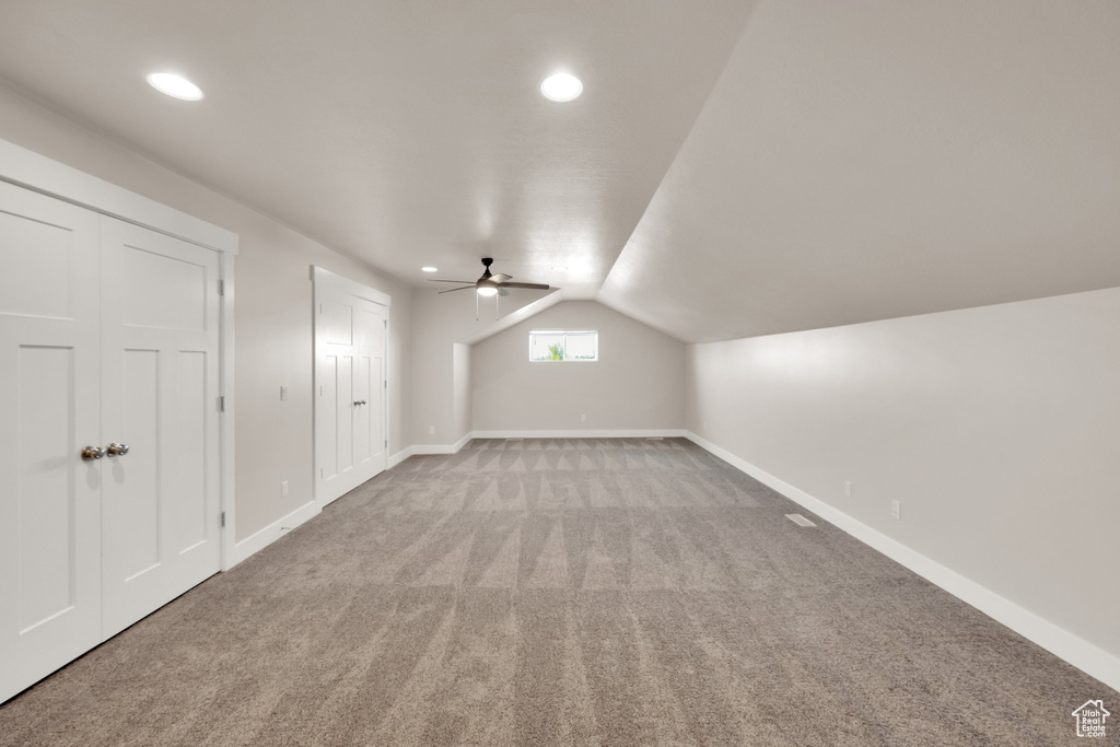 Additional living space with carpet floors, lofted ceiling, ceiling fan, baseboards, and recessed lighting