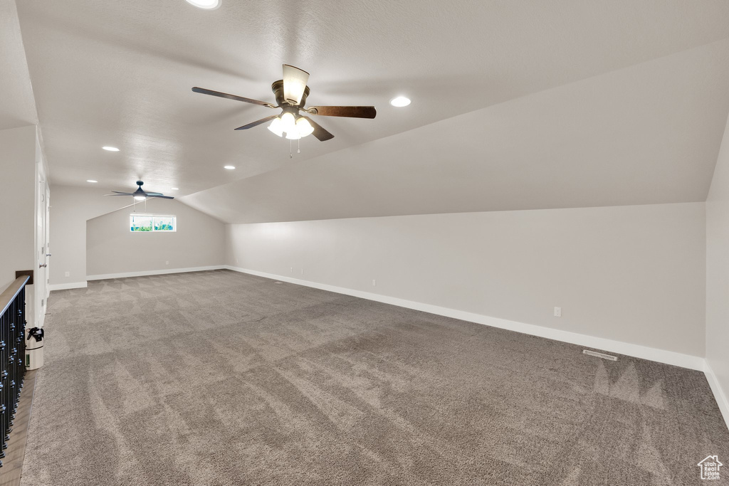 Additional living space with a ceiling fan, carpet flooring, vaulted ceiling, baseboards, and recessed lighting