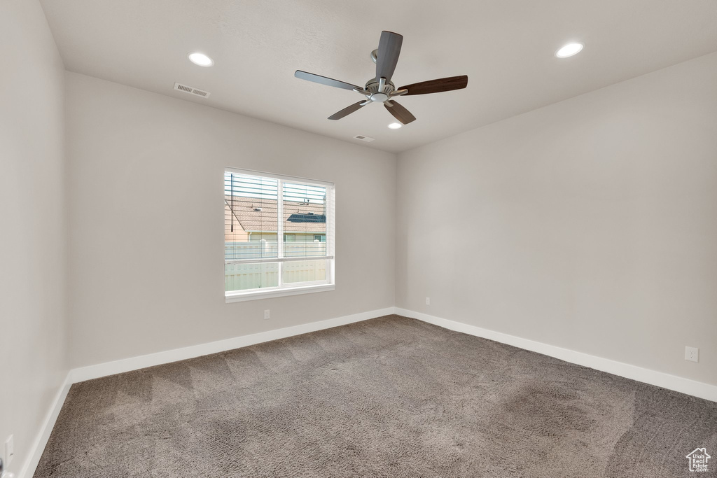 Empty room with carpet floors, recessed lighting, baseboards, and a ceiling fan