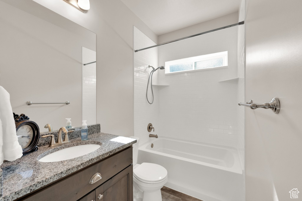 Full bathroom featuring toilet, bathtub / shower combination, and vanity