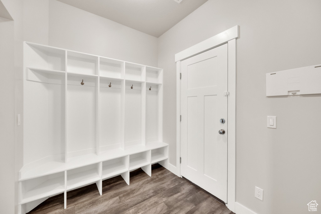 Mudroom featuring wood finished floors and baseboards