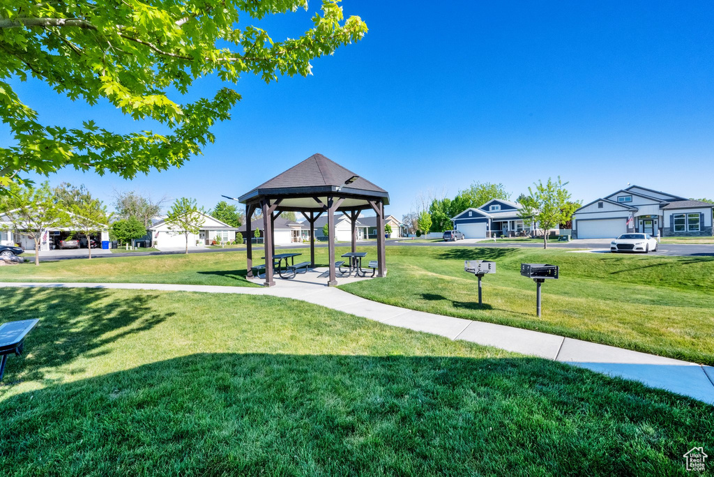 Surrounding community with a gazebo, a yard, and a residential view