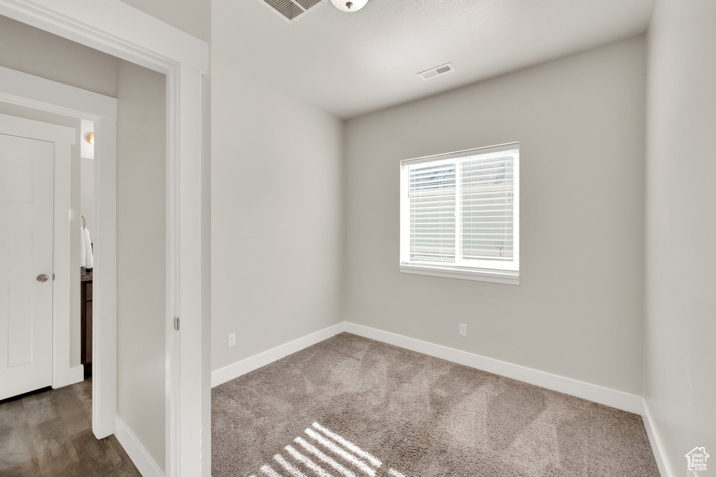 Carpeted spare room with baseboards