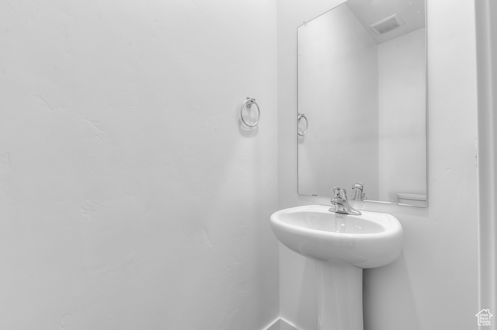 Bathroom with a sink and baseboards