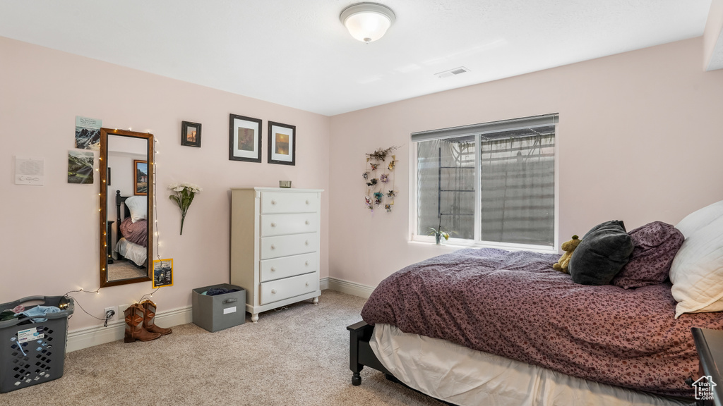 Bedroom featuring carpet floors and baseboards
