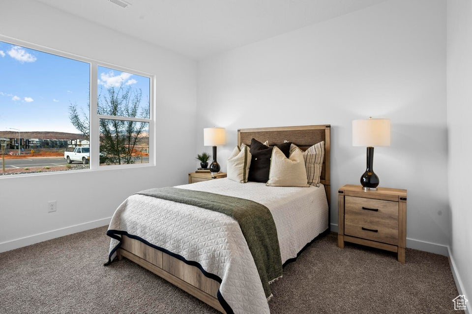Bedroom featuring carpet flooring and baseboards