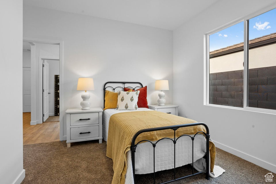 Carpeted bedroom with baseboards