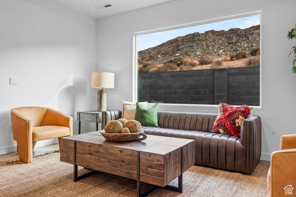 Living area featuring a mountain view and baseboards