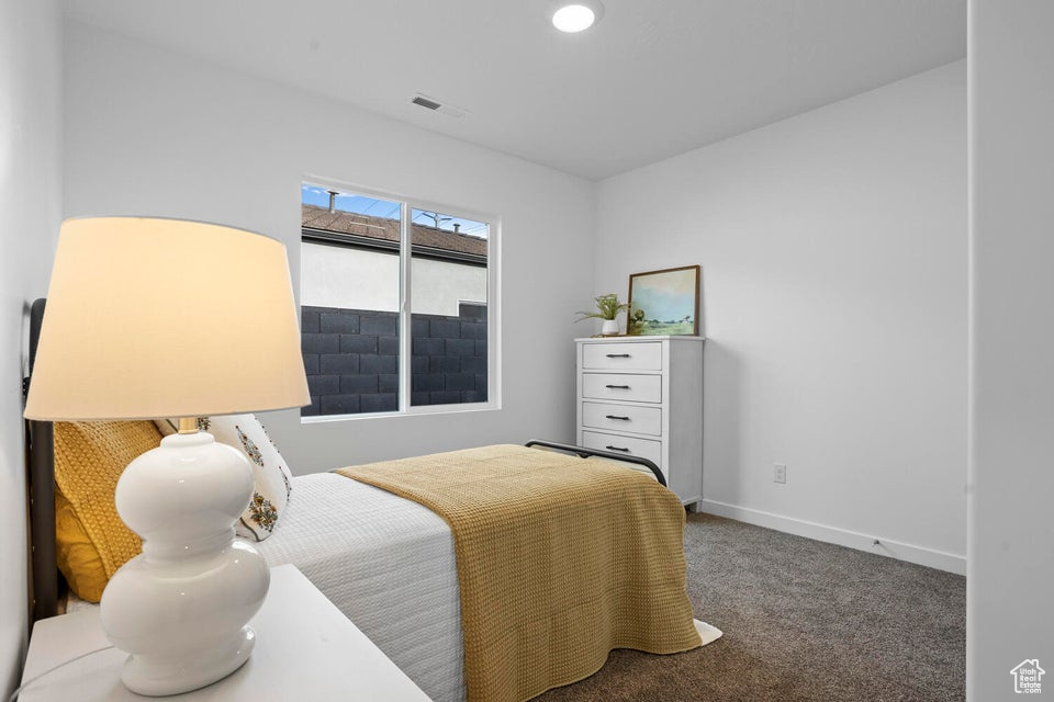 Carpeted bedroom featuring baseboards and recessed lighting