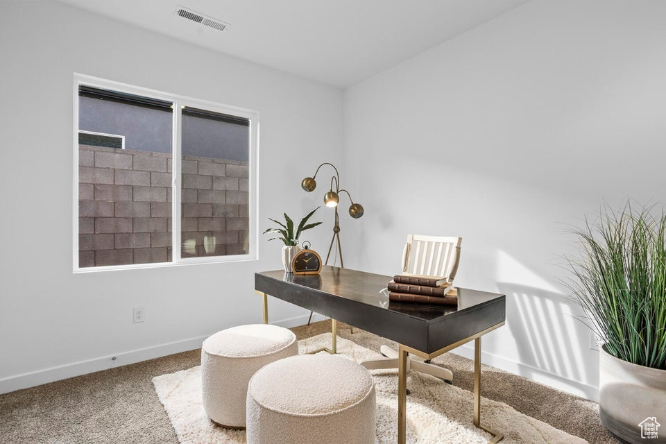 Carpeted office featuring baseboards