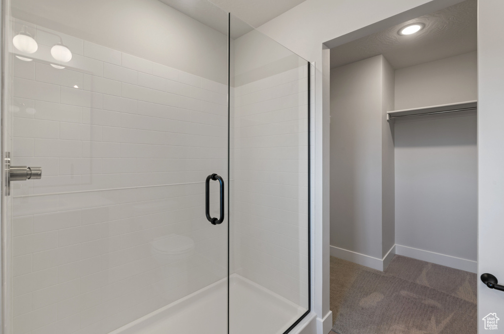 Full bathroom featuring a shower stall, baseboards, and recessed lighting