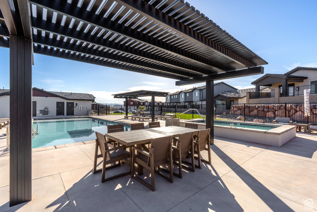 Community pool featuring fence, a pergola, and a patio