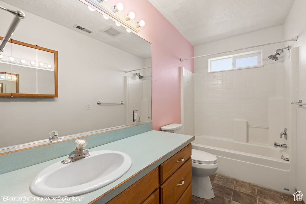 Bathroom with toilet, bathing tub / shower combination, and vanity