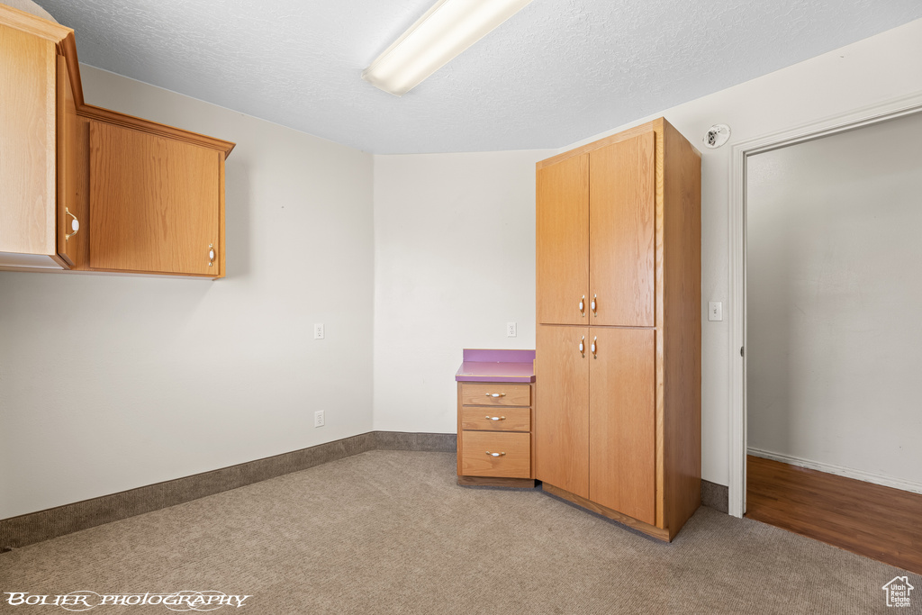 Unfurnished bedroom with carpet flooring, a closet, and baseboards