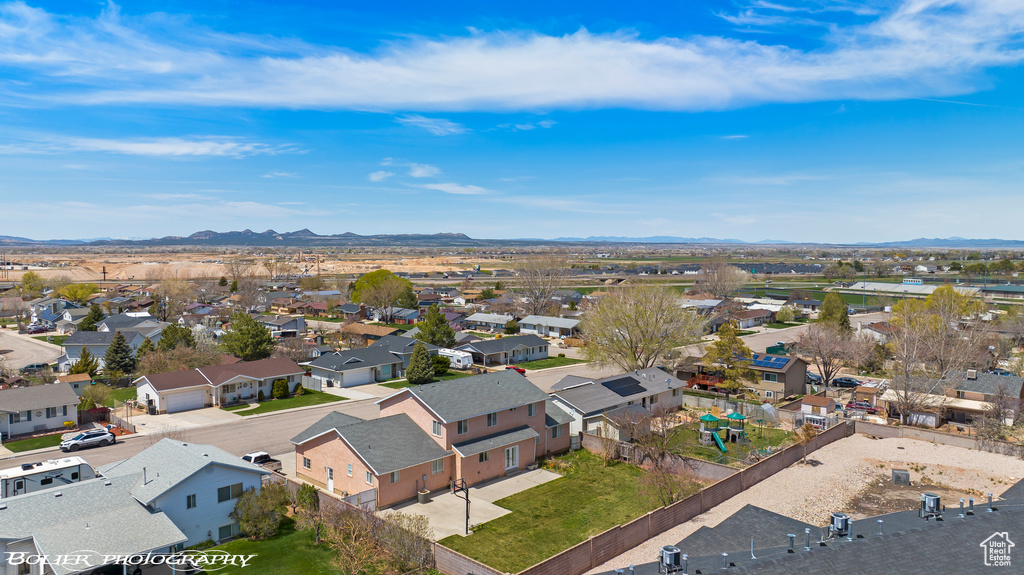 Aerial perspective of suburban area featuring a mountainous background