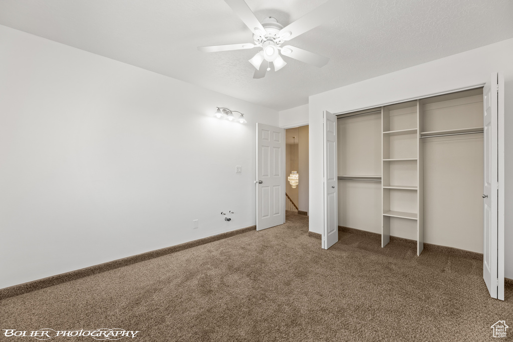 Unfurnished bedroom with carpet floors, baseboards, a ceiling fan, and a closet