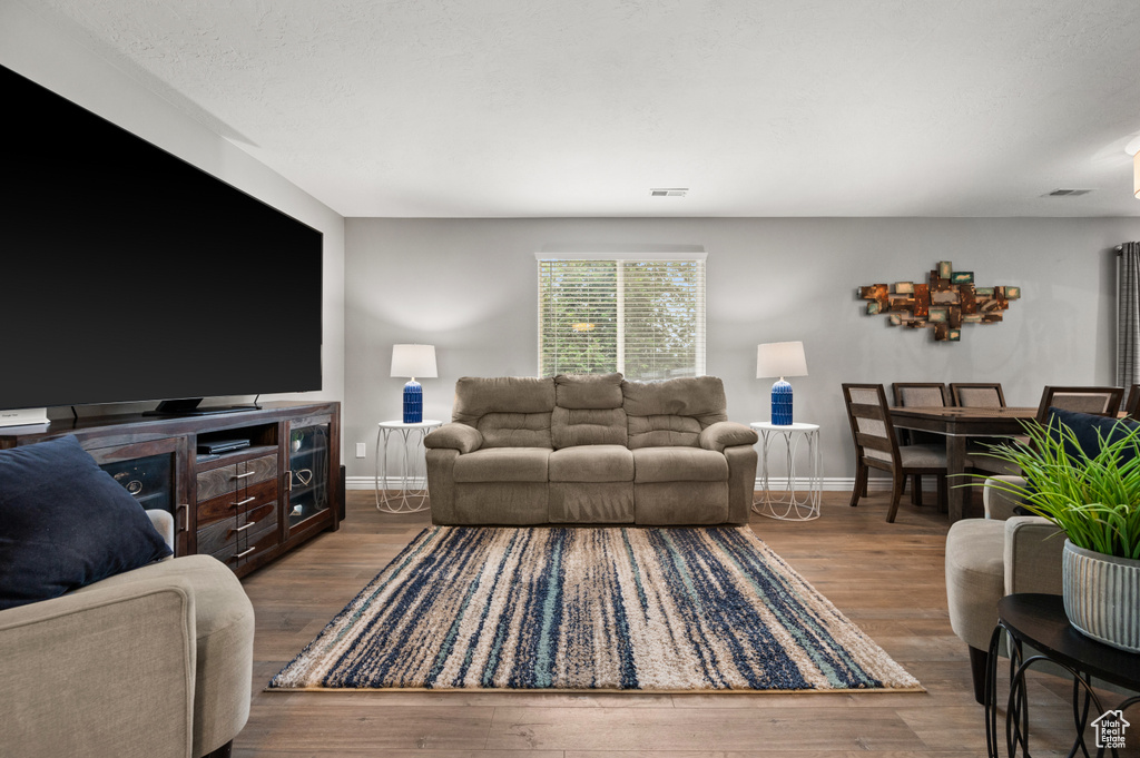 Living room featuring wood finished floors and baseboards