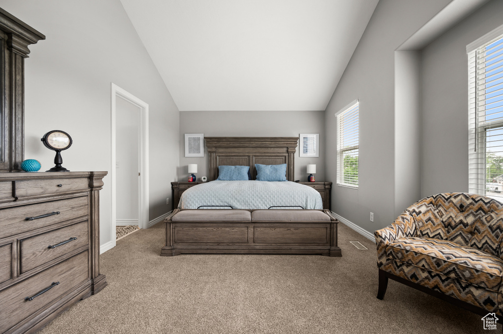 Bedroom with carpet, lofted ceiling, and baseboards