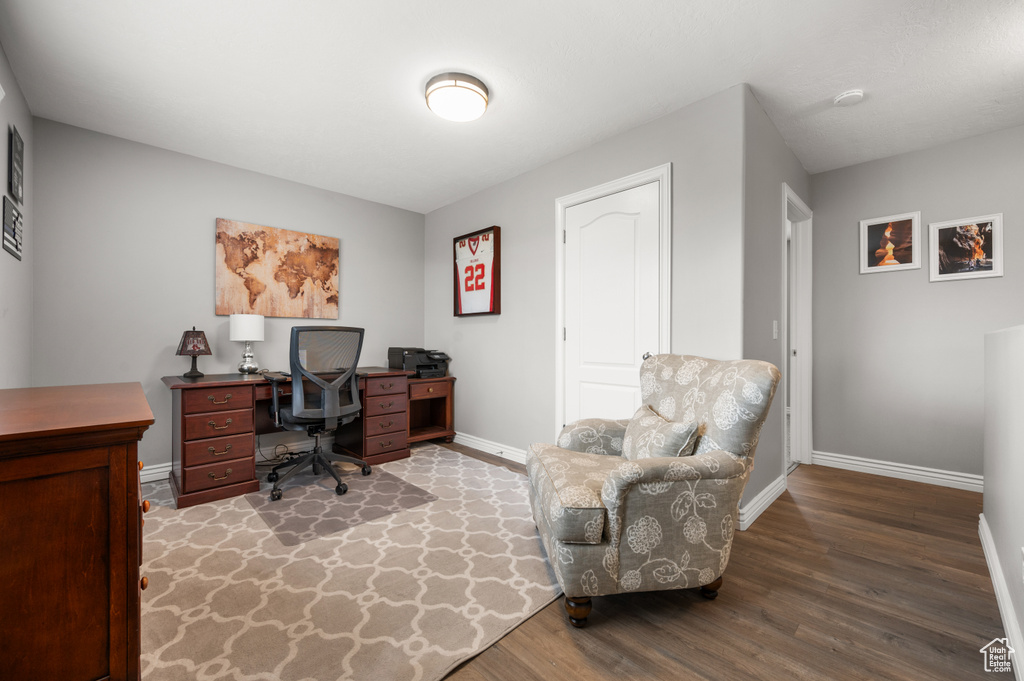 Home office featuring baseboards and wood finished floors