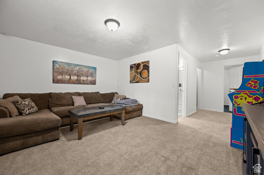 Living area featuring carpet flooring and baseboards