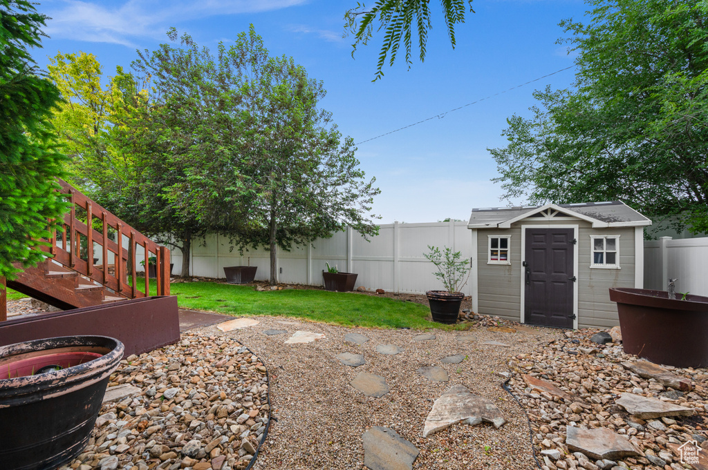 Fenced backyard with an outbuilding and a storage unit