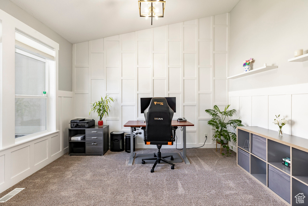 Home office with a decorative wall, carpet floors, and wainscoting