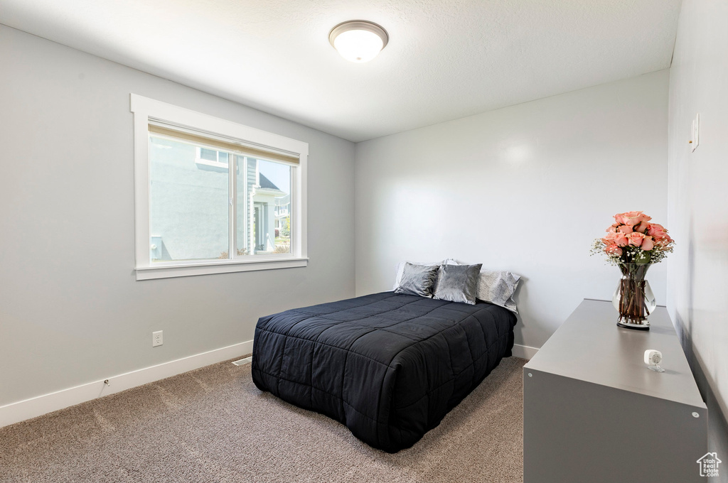 Carpeted bedroom featuring baseboards