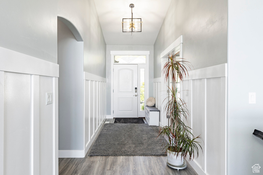 Entryway featuring wood finished floors and arched walkways