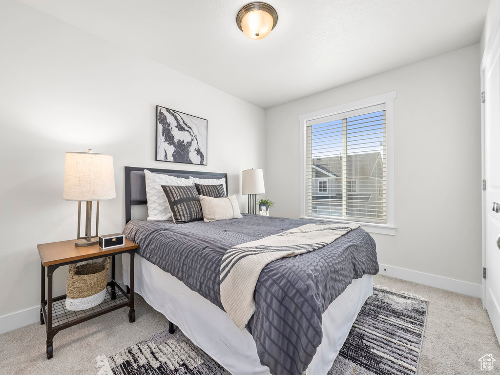 Carpeted bedroom with baseboards