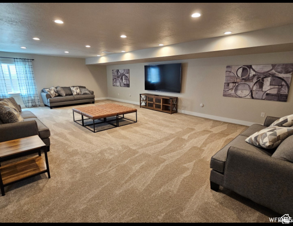 Living area featuring carpet, recessed lighting, and baseboards