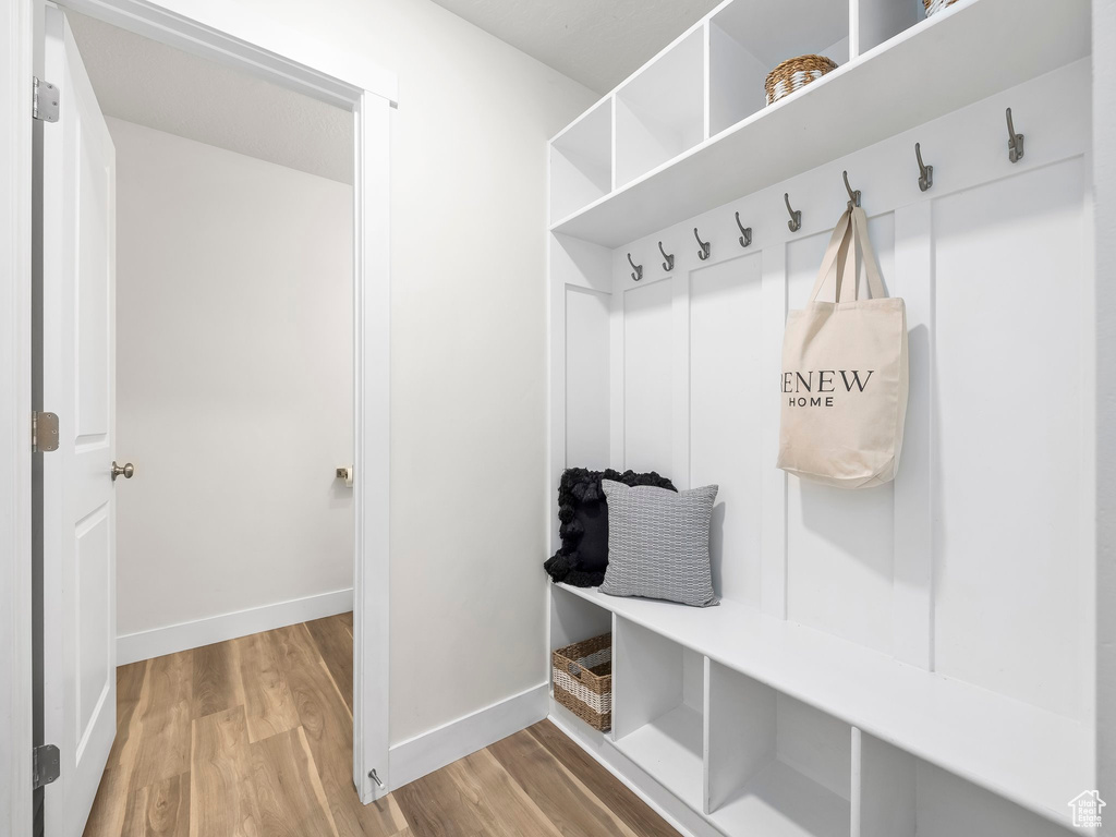 Mudroom featuring wood finished floors and baseboards