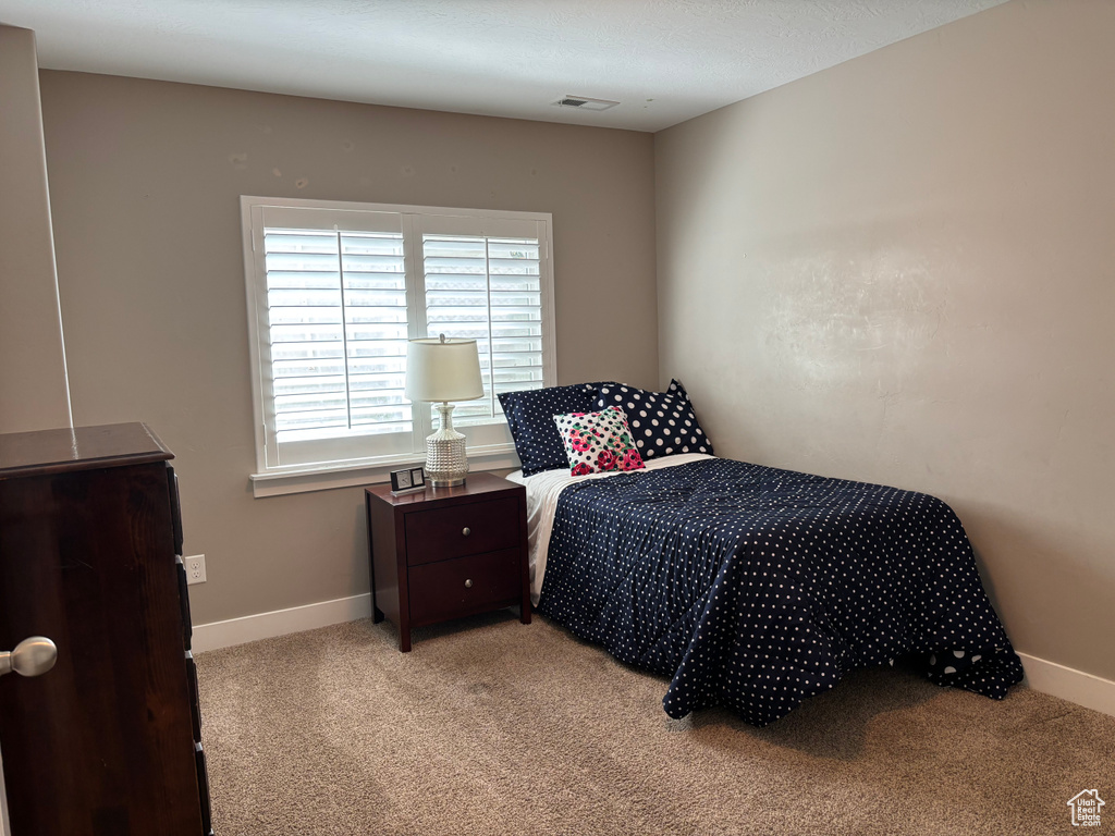 Carpeted bedroom with baseboards