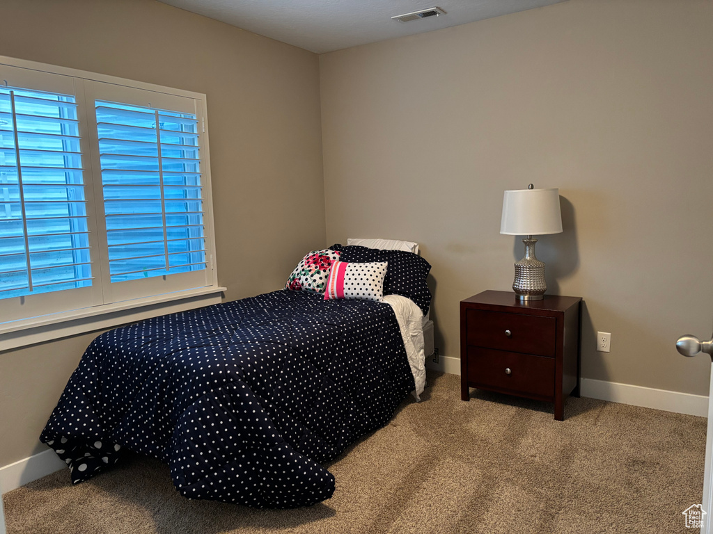 Carpeted bedroom with baseboards
