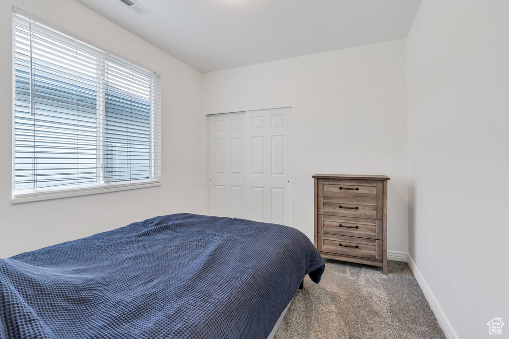 Carpeted bedroom featuring baseboards