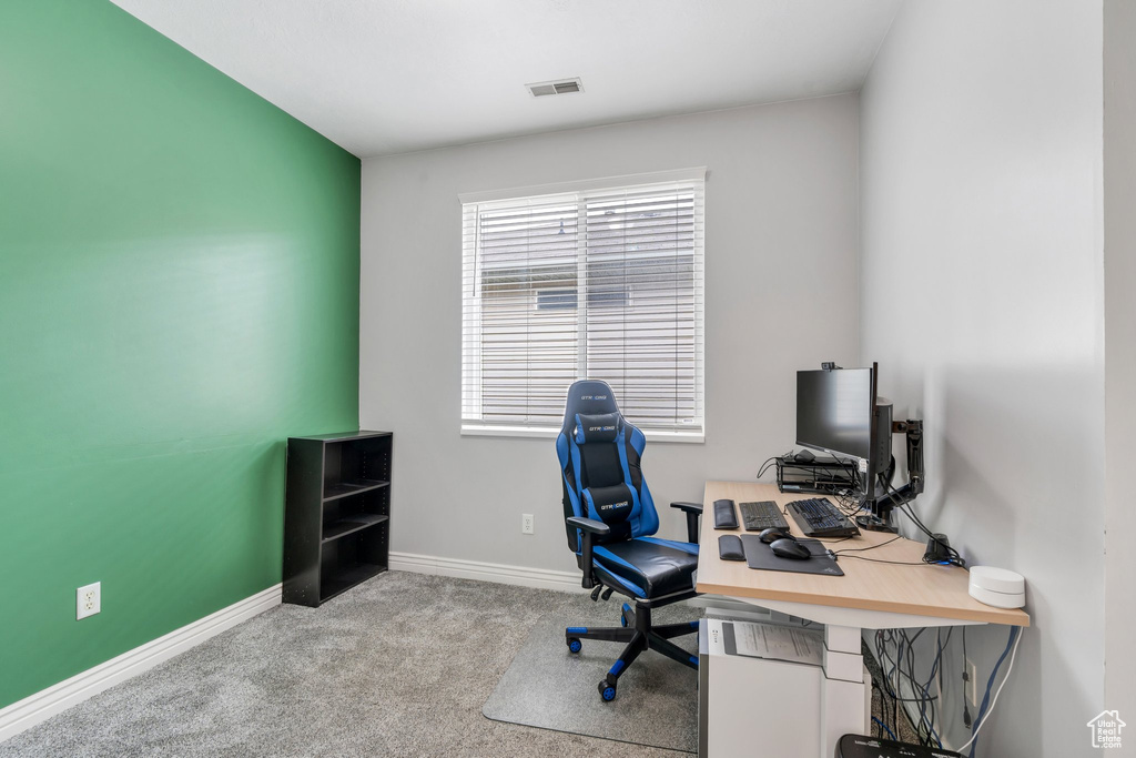 Carpeted office space with baseboards