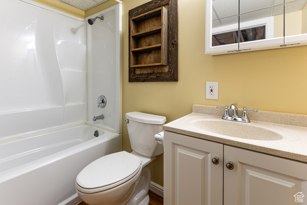 Bathroom with toilet, shower / tub combination, and vanity