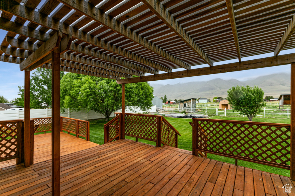 Deck featuring a mountain view and a pergola