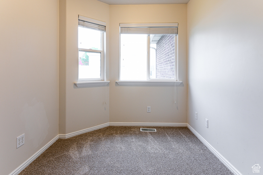 Empty room featuring carpet floors and baseboards