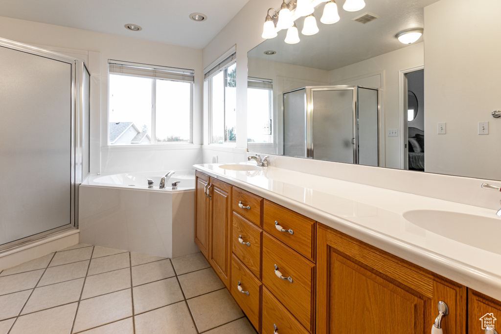 Bathroom with a stall shower, double vanity, a garden tub, and tile patterned floors