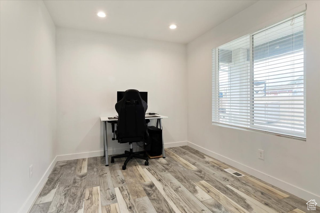 Office area featuring light wood-type flooring, baseboards, and recessed lighting