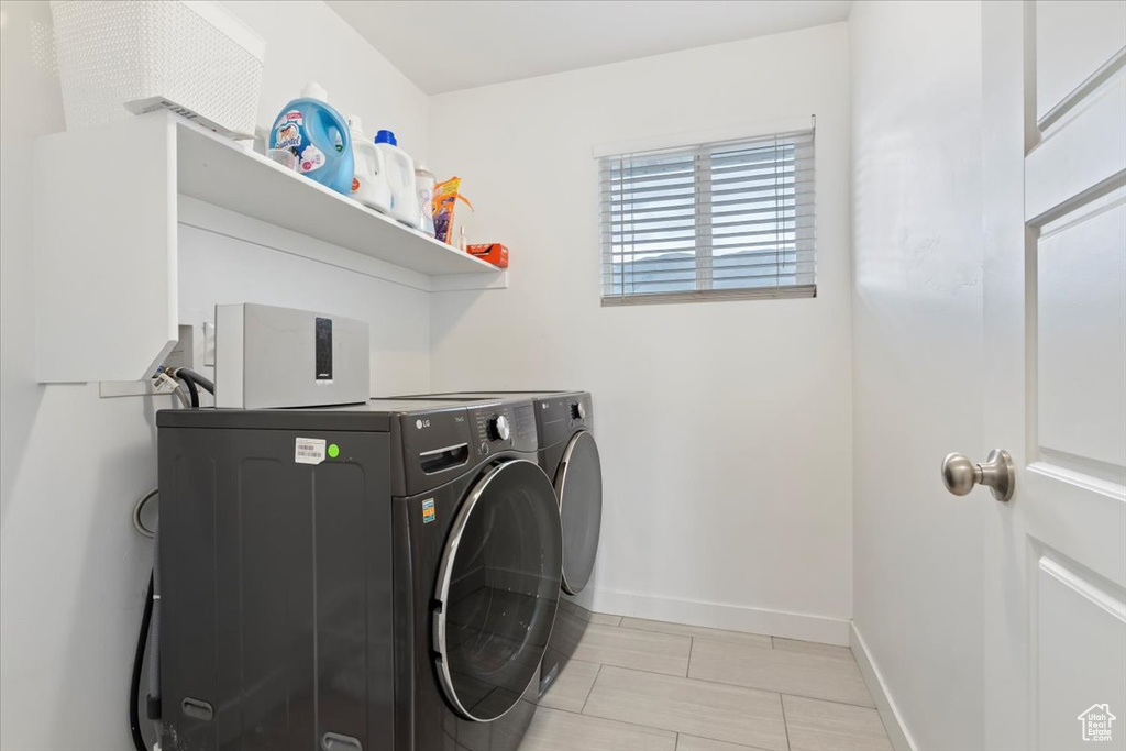 Laundry room with washing machine and dryer and baseboards