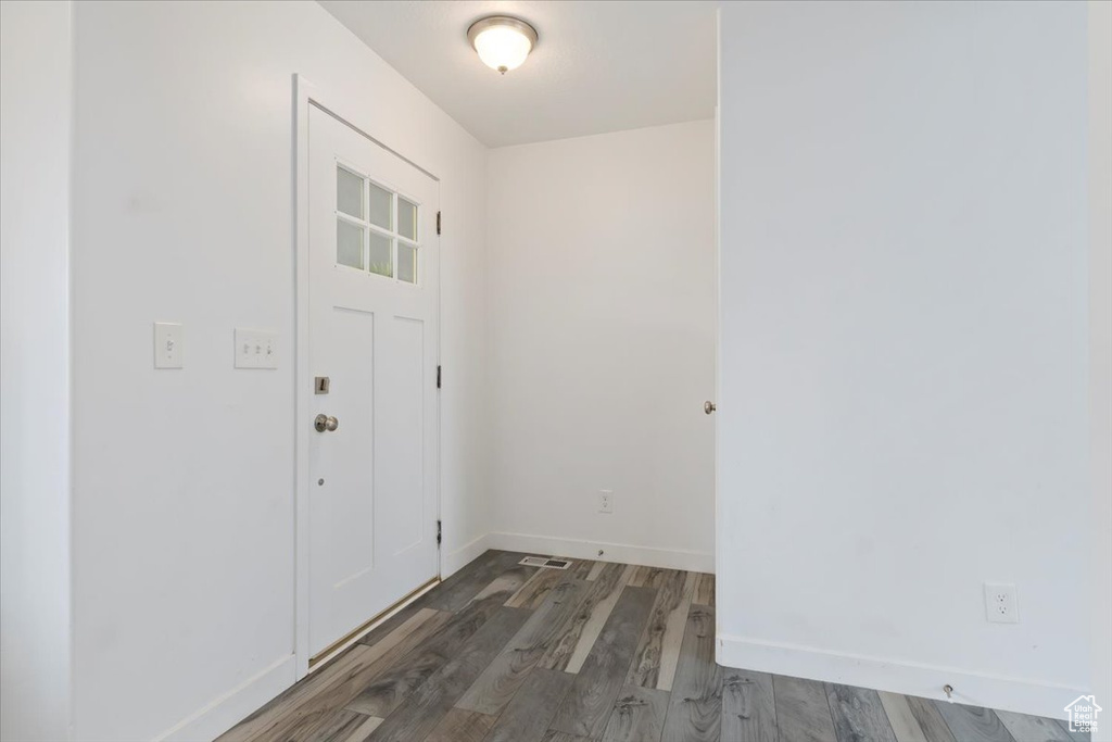 Foyer entrance featuring wood finished floors and baseboards