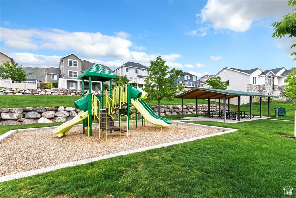 Communal playground with a residential view and a yard